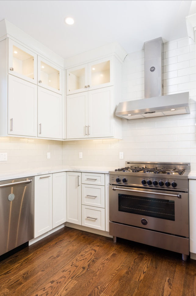 Sacked Soft white shaker kitchen with Cambria Britannica countertops, stainless steel hood