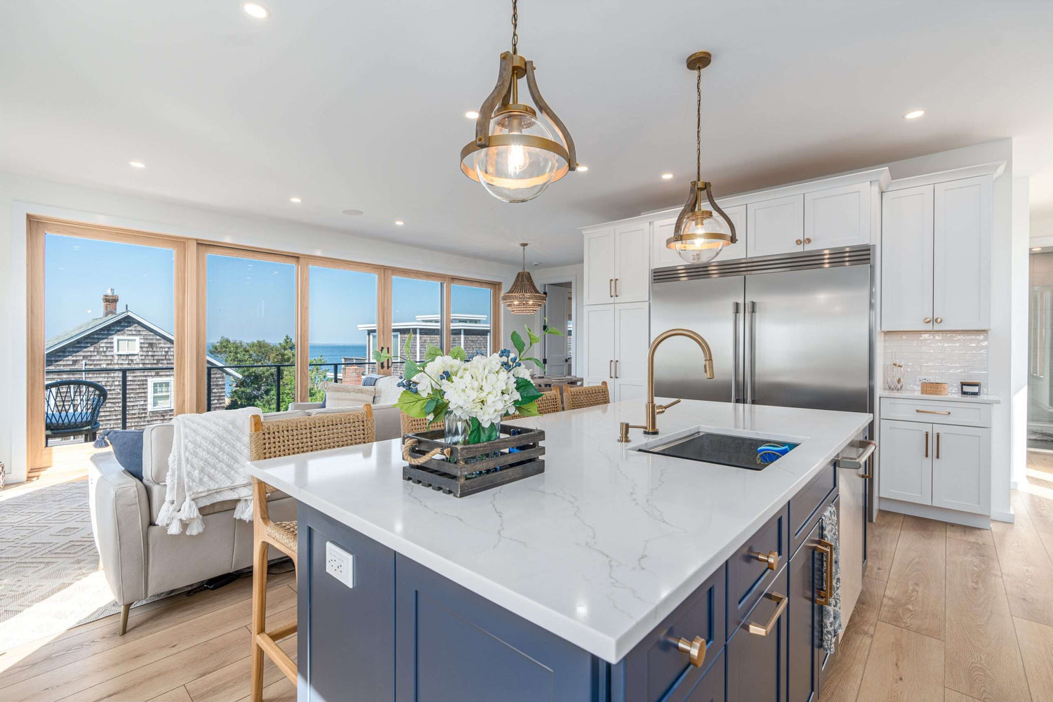 Coastal Blue and white kitchen with gold accents and white quartz countertops. Fabuwood Allure Galaxy Indigo Island