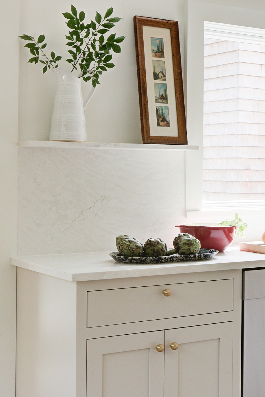 Cambria Delgatie Matte finish countertop, with full backsplash and decorative ledge.