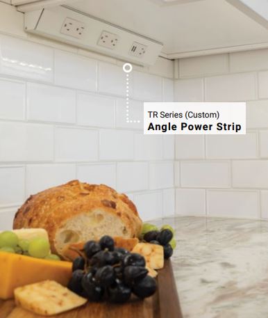 angled power strip for under cabinets installed  under white cabinets with white subway tile