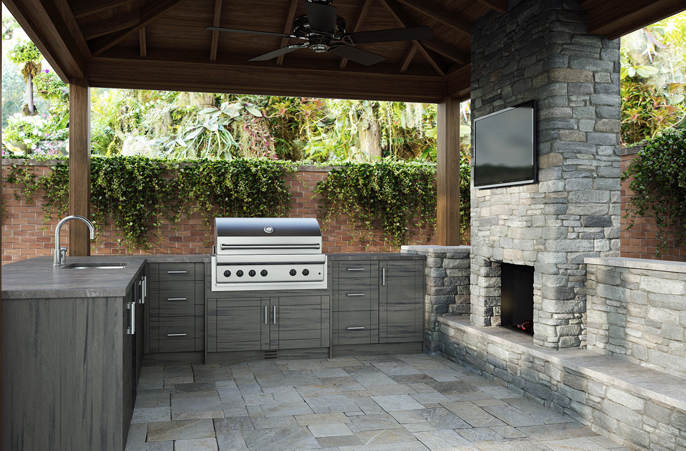 Gray outdoor cabinetry on a patio with an outdoor fireplace.